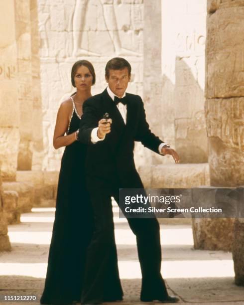 Actors Barbara Bach as Major Anya Amasova/Agent XXX and Roger Moore as James Bond at the temple of Karnak in Egypt, in the film 'The Spy Who Loved...