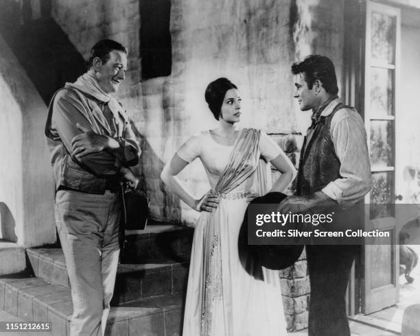 From left to right, actors John Wayne as Captain Jake Cutter, Ina Balin as Pilar Graile and Stuart Whitman as Paul Regret in the Western film 'The...