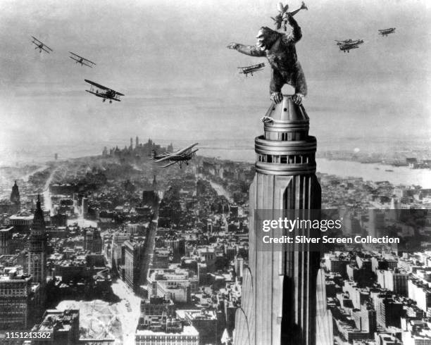 The giant ape fights off planes atop the Empire State Building in New York City at the end of the film 'King Kong', 1933.