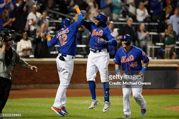 Rajai Davis of the New York Mets celebrates with Juan Lagares after hitting a three run home run against the Washington Nationals in the eighth...