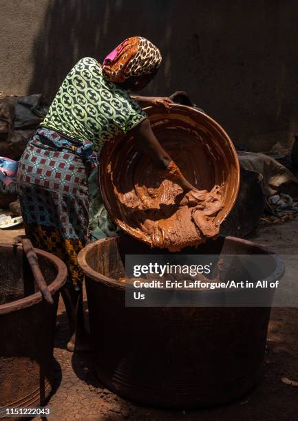 Senufo woman prepairing shea butter in a traditional karité factory, Savanes district, Tcheregnimin, Ivory Coast on May 2, 2019 in Tcheregnimin,...