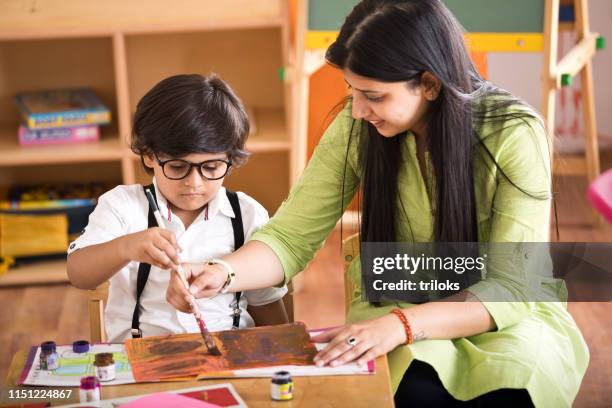 children with teacher in drawing class - asian teacher stock pictures, royalty-free photos & images