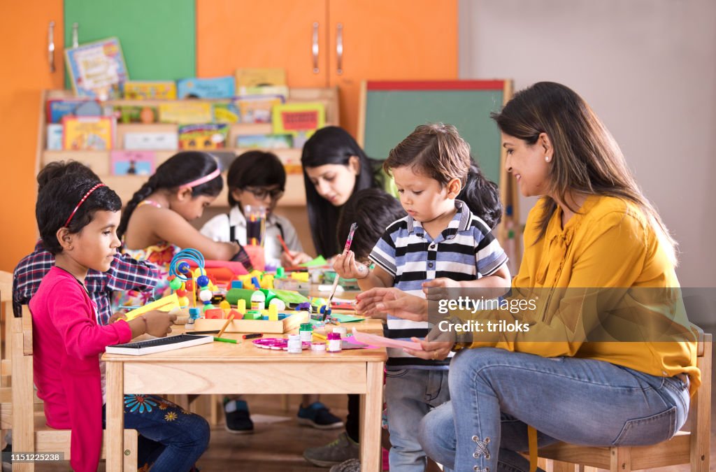 Children with teacher in art class
