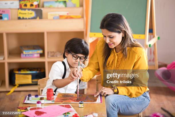 children with teacher in drawing class - kids painting stock pictures, royalty-free photos & images