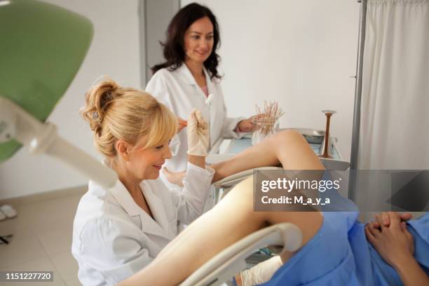 gynaecologist examining a patient - gynecological chair stock pictures, royalty-free photos & images