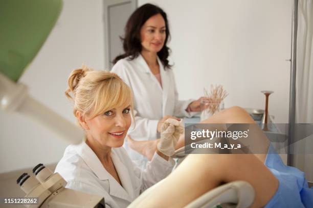 gynaecologist examining a patient - gynecological chair stock pictures, royalty-free photos & images