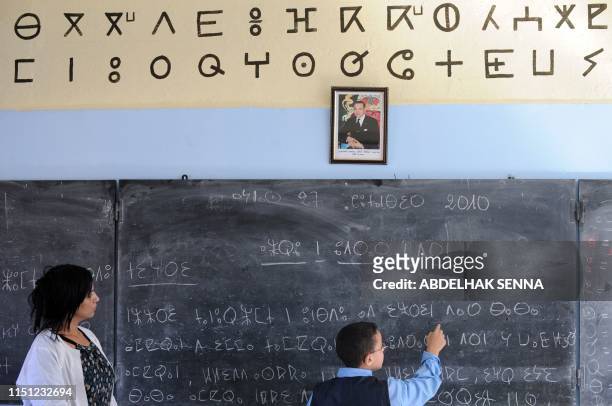 School teacher helps a pupil reads a text in Amazigh, an ancient tongue, on September 27, 2010 in Rabat. The Amazigh language was first introduced in...