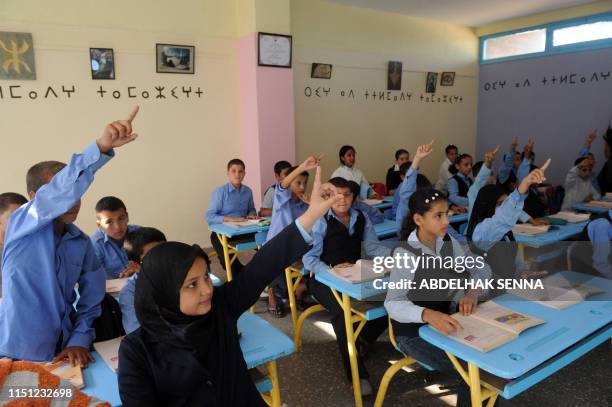 Pupils raise their hands during an Amazigh class, on September 27, 2010 in Rabat. The Amazigh language was first introduced in elementary classes in...