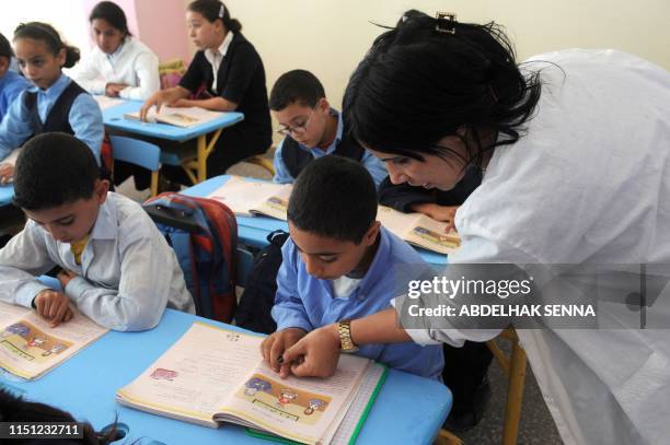 School teacher helps students read Amazigh, an ancient tongue, on September 27, 2010 in Rabat. The Amazigh language was first introduced in...