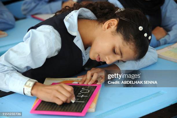 Pupils write on a blackboard during an Amazigh class, on September 27, 2010 in Rabat. The Amazigh language was first introduced in elementary classes...