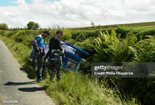 Letterkenny , Ireland - 21 June 2019; Ken Block, left, and co-driver Alex Gelsomino inspect their Escort Cosworth which crashed on SS 2 Grianan...