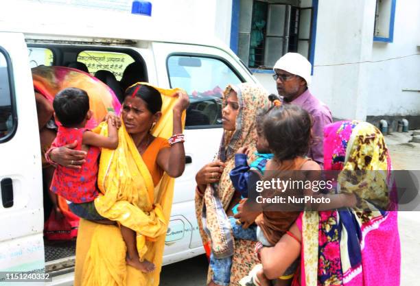 Indian local women of Minapur village arrive by an amulance with their children for the checkup of AES at community health centre , some 30 kms from...