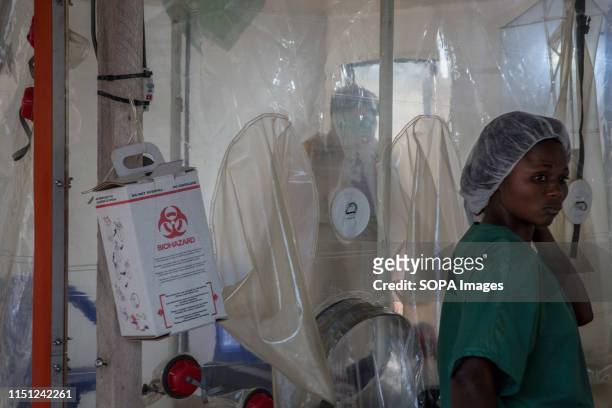 Doctor wearing full protective gear speaks to a patient in the Ebola treatment centre in Beni, eastern Democratic Republic of the Congo. The DRC is...