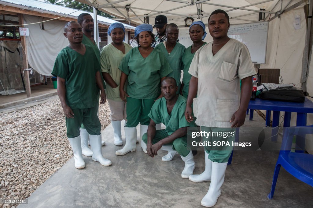 Front line healthcare workers pose in the Ebola treatment...