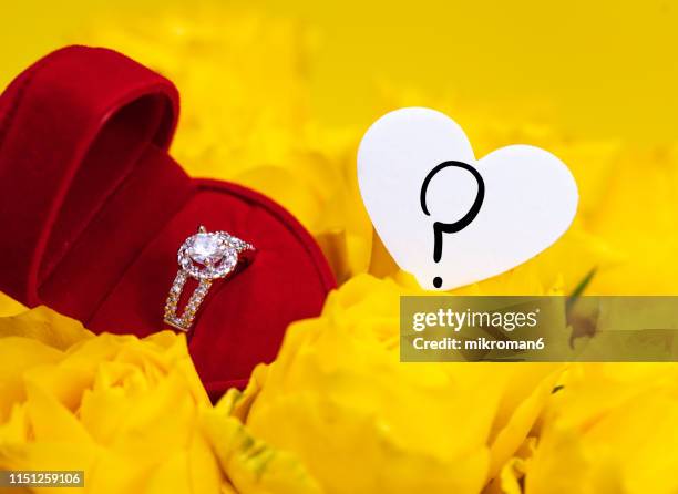 engagement ring and yellow roses with question mark - anniversary mark stock pictures, royalty-free photos & images