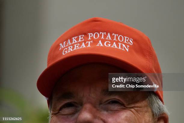Dan Moss, of the National Potato Council, dons his 'Make Potatoes Great Again' hat before joining U.S. President Donald Trump in the Roosevelt Room...