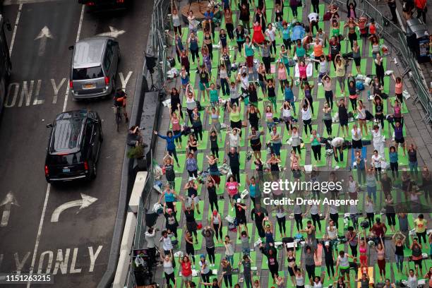 Yoga enthusiasts participate in a mass yoga class in Manhattan's Times Square to celebrate the summer solstice and mark World Yoga Day, June 21, 2019...