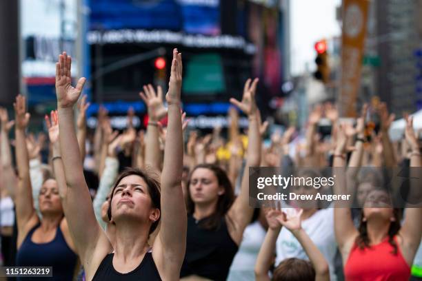 Yoga enthusiasts participate in a mass yoga class in Manhattan's Times Square to celebrate the summer solstice and mark World Yoga Day, June 21, 2019...