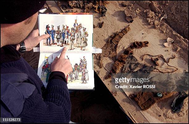 Mass grave containing remains of Napoleonic soldiers discovered in Vilnius, France on April 04, 2002 - Olivier Dutour compares drawings with tunic...