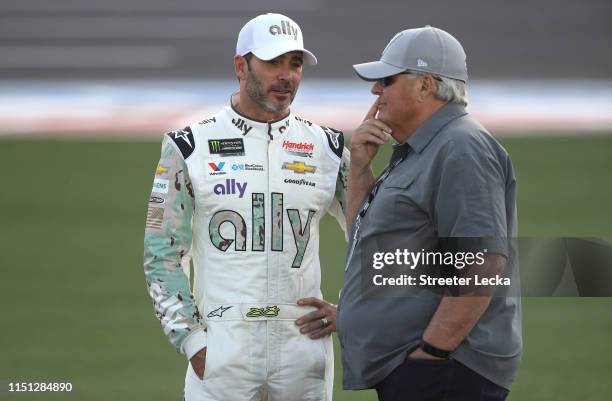 Jimmie Johnson, driver of the Ally Patriotic Chevrolet, and NASCAR Hall of Famer and team owner Rick Hendrick talk during qualifying for the Monster...