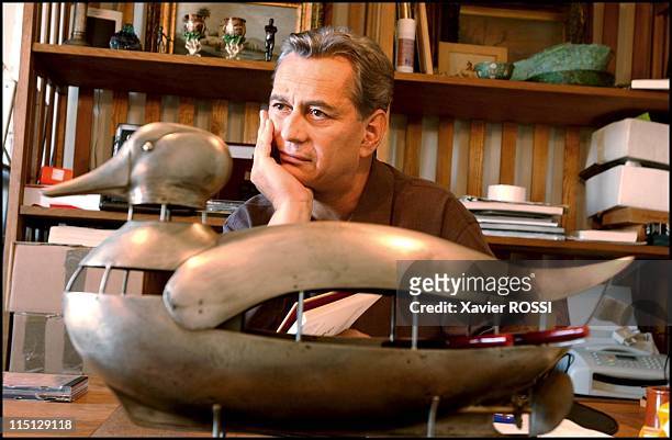 Close up Igor Mitoray, sculptor in Paris, France in September, 2002 - Mitoray with one of his beloved objets a duck by Lalanne.