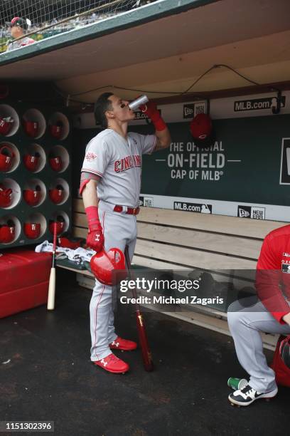 Derek Dietrich of the Cincinnati Reds stands in the dugout prior to the game against the Oakland Athletics at the Oakland-Alameda County Coliseum on...