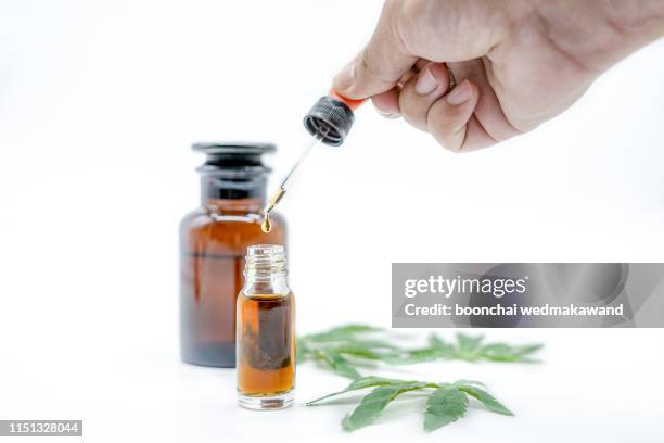 hand holding bottle of cannabis oil in, natural herb, medical marijuana concept, cbd cannabis oil. hemp product, close up, - cannabis oil fotografías e imágenes de stock