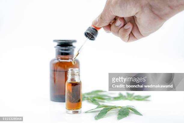 hand holding bottle of cannabis oil in, natural herb, medical marijuana concept, cbd cannabis oil. hemp product, close up, - cannabis oil - fotografias e filmes do acervo
