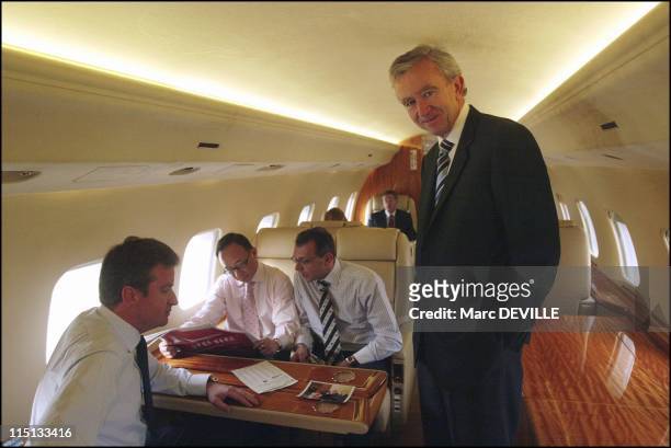 Bernard Arnault on board his private jet between Beijing and Shanghai. In Shanghai, China on October 11, 2004 - With his board: from left to right:...