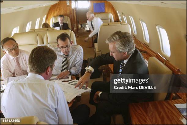 Bernard Arnault on board his private jet between Beijing and Shanghai. In Shanghai, China on October 11, 2004 - With his board: from left to right:...