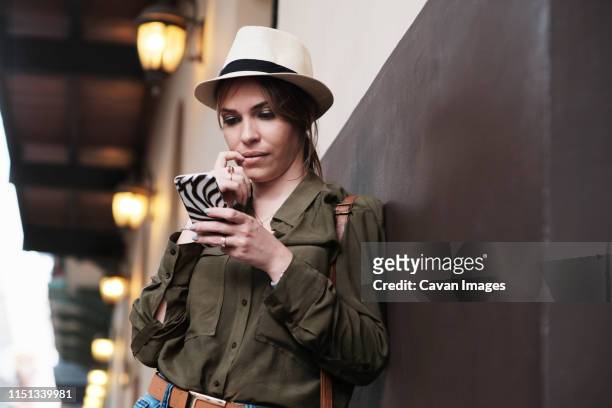 woman as tourist lost direction and looks at gps map on mobile phone - female worried mobile imagens e fotografias de stock