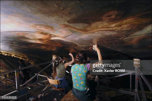 Chateau de Versailles: restoring the famed Galerie des Glaces in Versailles, France on May 30, 2005 - On a mobile platform, these restorers are...