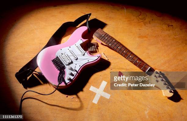 smashed guitar at end of rock and roll performance - rock object stock pictures, royalty-free photos & images