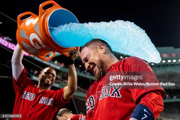 Christian Vazquez of the Boston Red Sox is doused with Gatorade by Xander Bogaerts after hitting a game winning walk-off two run home run during the...