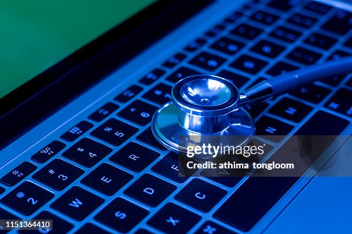 Computer or data analysis - Stethoscope over a computer keyboard toned in blue Computer or data analysis - Stethoscope over a computer keyboard toned in blue