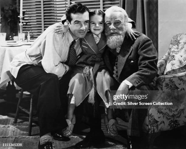 From left to right, actors John Payne as Fred Gailey, Natalie Wood as Susan Walker, and Edmund Gwenn as Kris Kringle in the film 'Miracle on 34th...