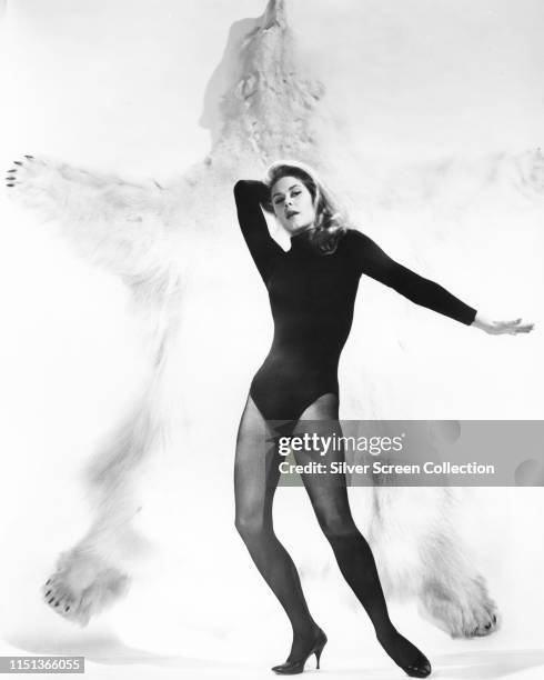 American actress Elizabeth Montgomery poses against a polar bear rug, circa 1963.