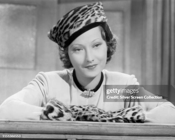 Actress Merle Oberon wearing a leopardskin hat and muff, circa 1940.