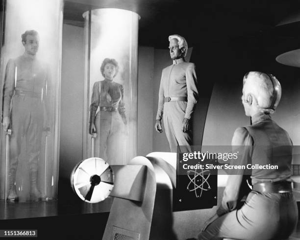 Actors Rex Reason as Dr Cal Meacham, Faith Domergue as Dr Ruth Adams and Jeff Morrow as Exeter in the science fiction film 'This Island Earth', 1955.