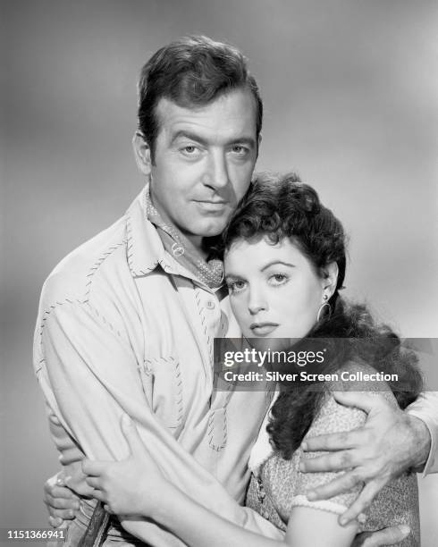 Actors John Payne as Kirby Randolph and Faith Domergue as Aurelie St. Clair in a promotional shot for the Western 'Santa Fe Passage', 1955.