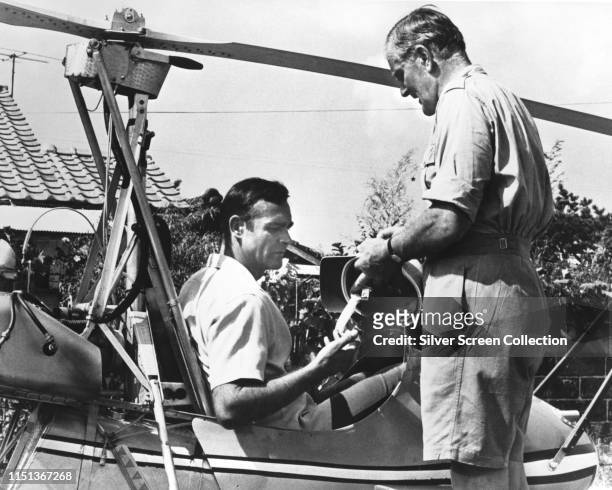 Actors Sean Connery as James Bond and Desmond Llewelyn as Q with the WA-116 autogyro 'Little Nellie' in the spy film 'You Only Live Twice', 1967.