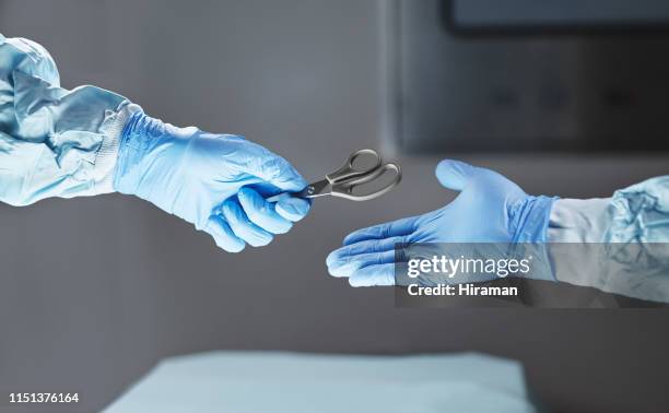 specialising in cutting edge surgery - protective glove stock pictures, royalty-free photos & images