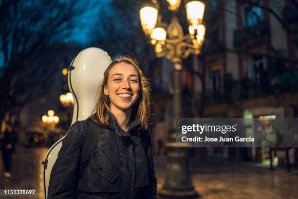 young girl carrying instrument - girl cello stock pictures, royalty-free photos & images