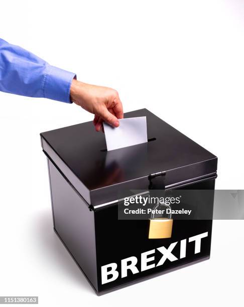 man's hand casting vote in brexit election ballot box - election box stock pictures, royalty-free photos & images