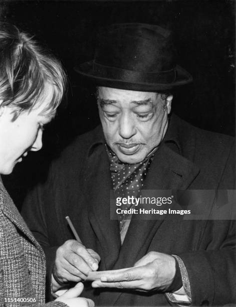 Duke Ellington signing his autograph, circa 1962. Artist Brian Foskett.