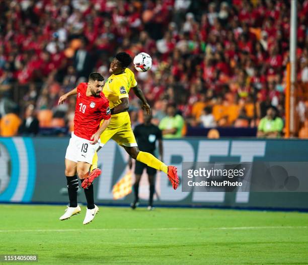 Abdallah Mahmoud Said Mohamed Bekhit of Egypt and Marshal Nyasha Munetsi of Zimbabwe challenging for the ball during the African Cup of Nations match...