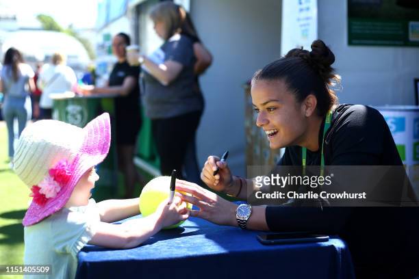 Maria Sakkari of Greece signs autographs for fans during qualifying for the Nature Valley International at Devonshire Park on June 22, 2019 in...