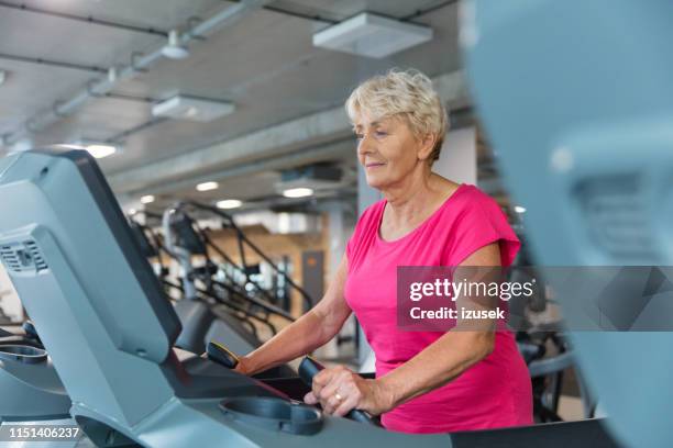 fit senior woman exercising on treadmill - drug rehab stock pictures, royalty-free photos & images