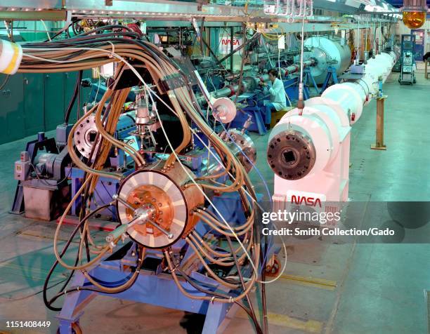 Electric Arc Shock Tube's driver with its power cables, collector assembly, and pneumatic cylinder, Ames Research Center, Mountain View, California,...