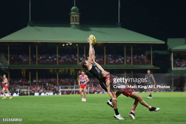 Rupert Wills of the Magpies competes for the ball against Jake Lloyd of the Swans during the round 10 AFL match between the Sydney Swans and the...